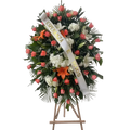 Corona Fúnebre Tranquilidad con lirios, rosas rosadas, hortensias y rosas blancas.